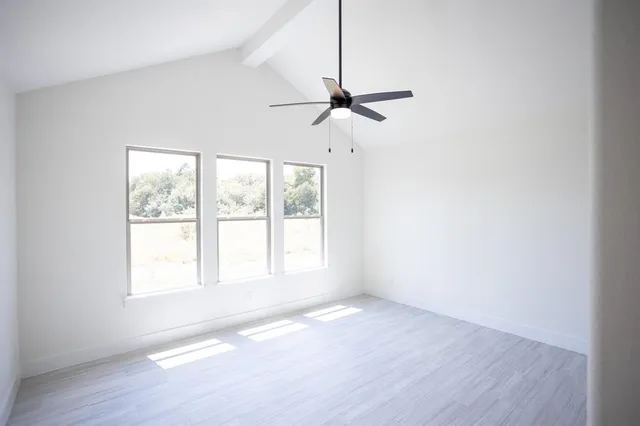 a view of a room with wooden floor