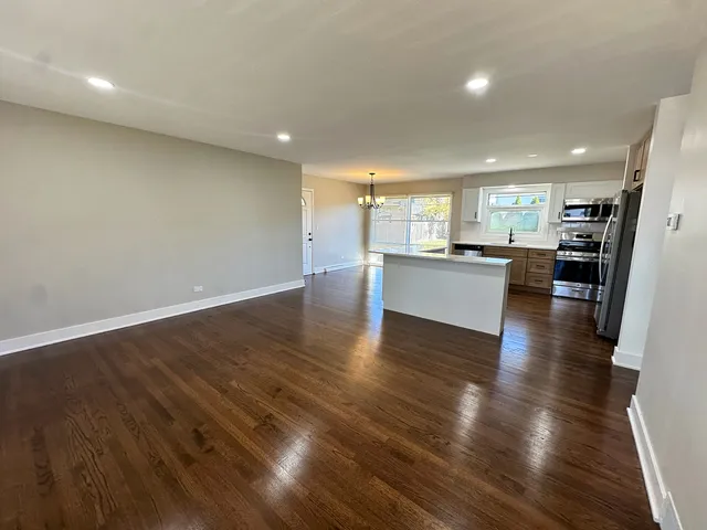 a view of a kitchen with a sink stainless steel appliances and cabinets