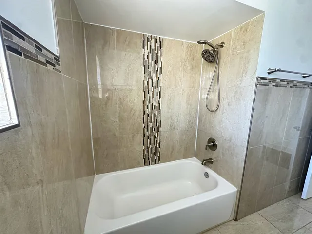 a bathroom with a shower and a bathtub