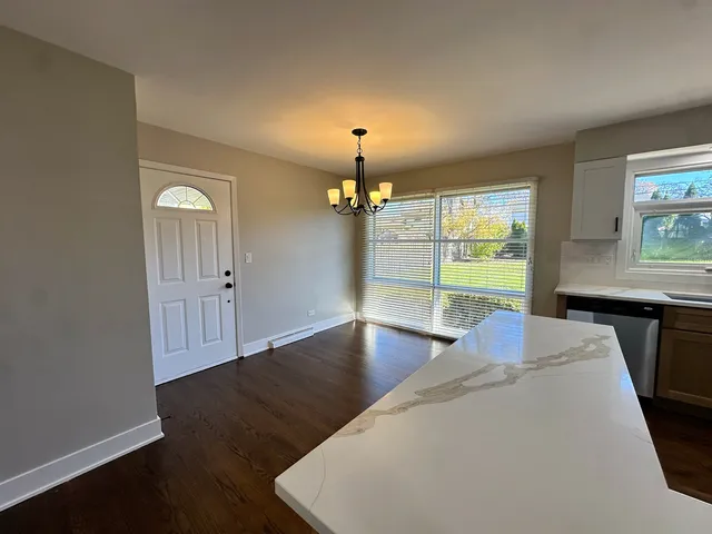 a view of a livingroom with furniture window and wooden floor
