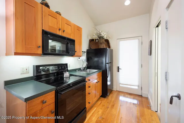 a kitchen with stainless steel appliances granite countertop a stove refrigerator and microwave