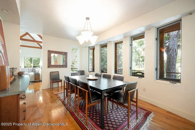 a view of a dining room with furniture wooden floor and chandelier