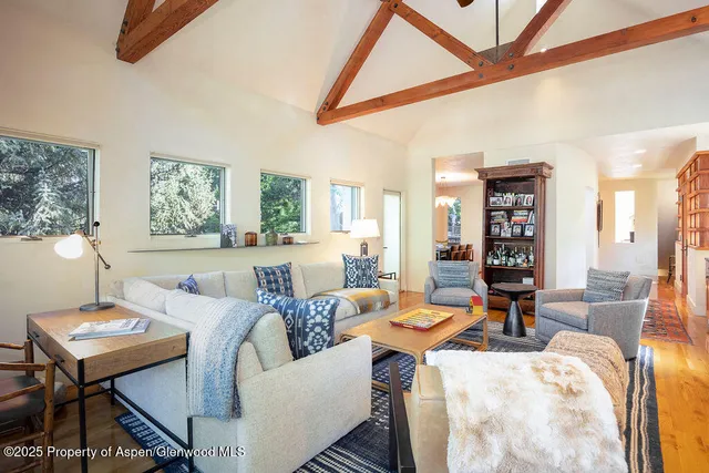 a living room with furniture a rug and a table