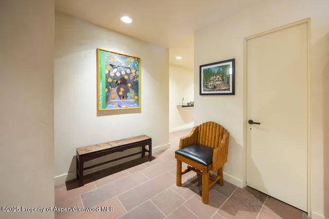 a living room with furniture and a chair