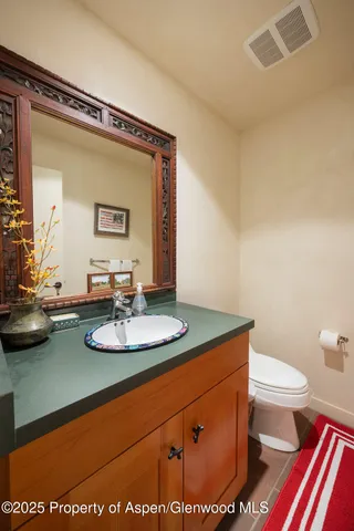 a bathroom with a sink mirror vanity and toilet