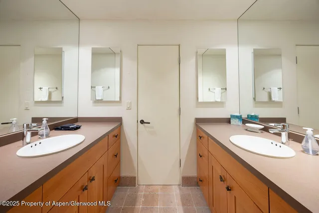 a bathroom with a sink double vanity and a mirror