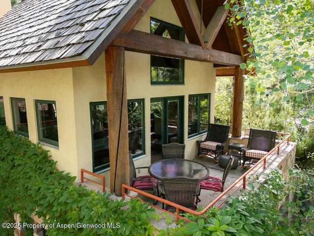 a building outdoor space with patio furniture and potted plants