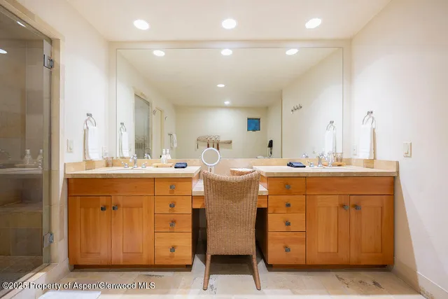 a bathroom with a sink double vanity and a mirror