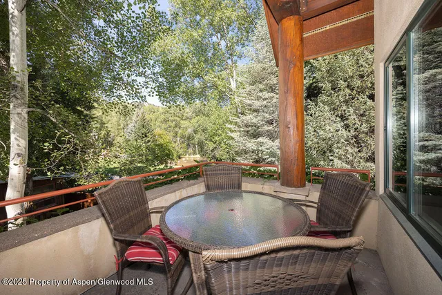 a view of balcony with a table and chairs
