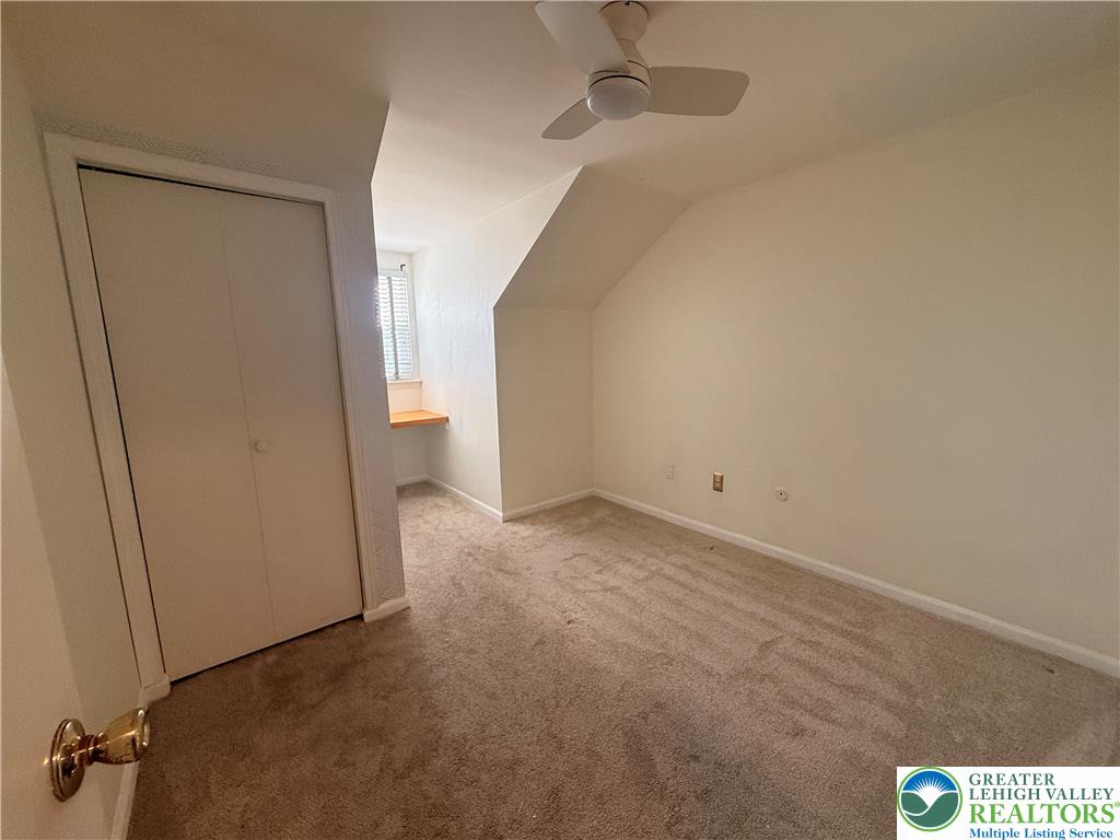 170 Springhouse Road Allentown, PA 18104 - Photo 13 of 23 A versatile room with soft carpeting, a convenient built-in desk, and an angled ceiling.