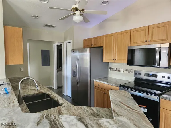a kitchen with a appliances and cabinets