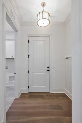 a view of storage and utility room with wooden floor