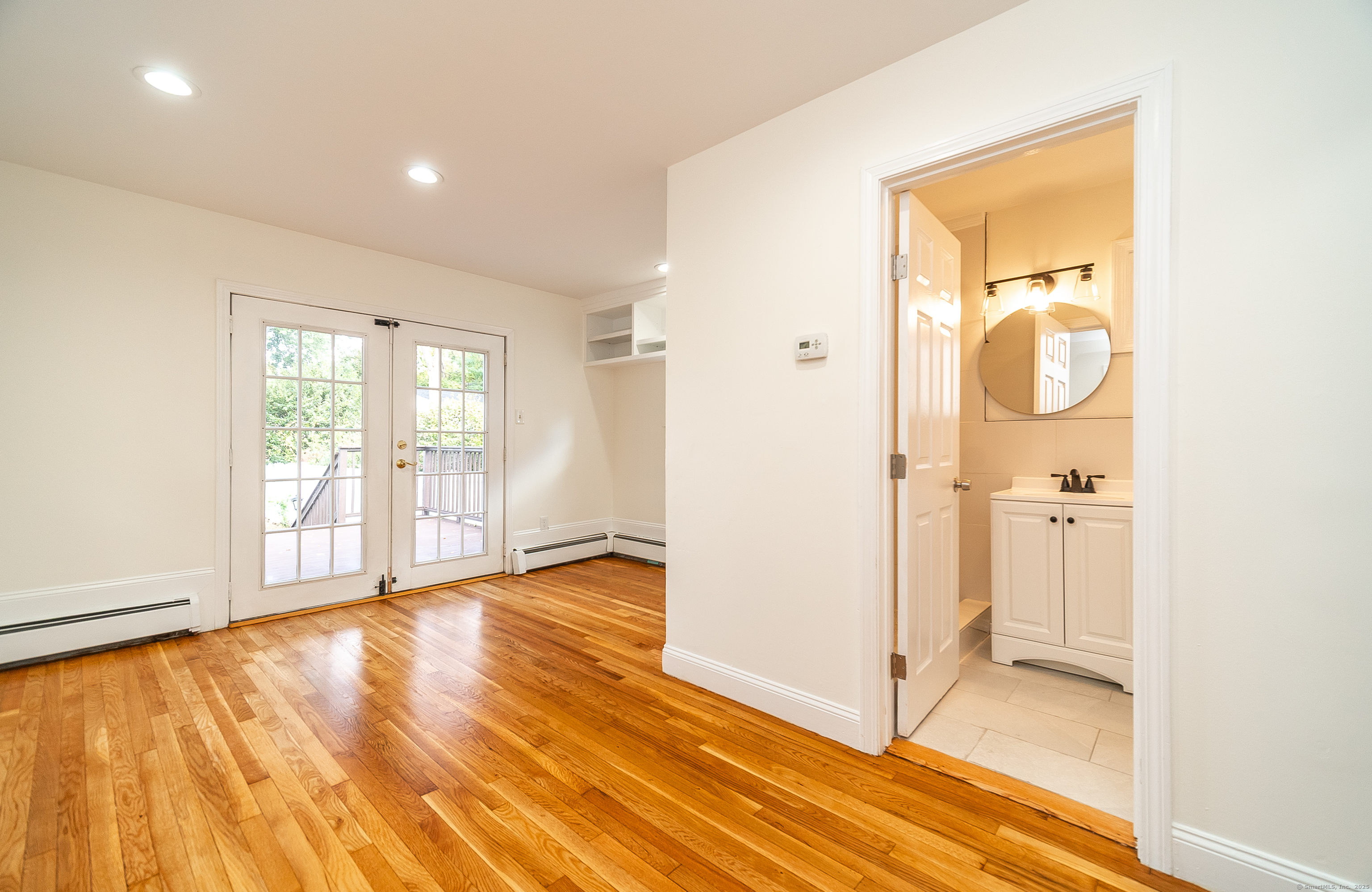 78 Warren Street Stamford, CT 06902 - Photo 11 of 40 a view of an empty room with wooden floor and a window