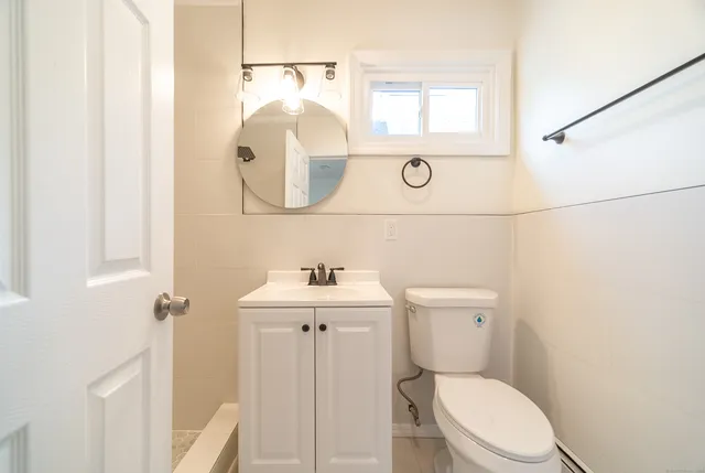 a white toilet sitting next to a bathroom sink