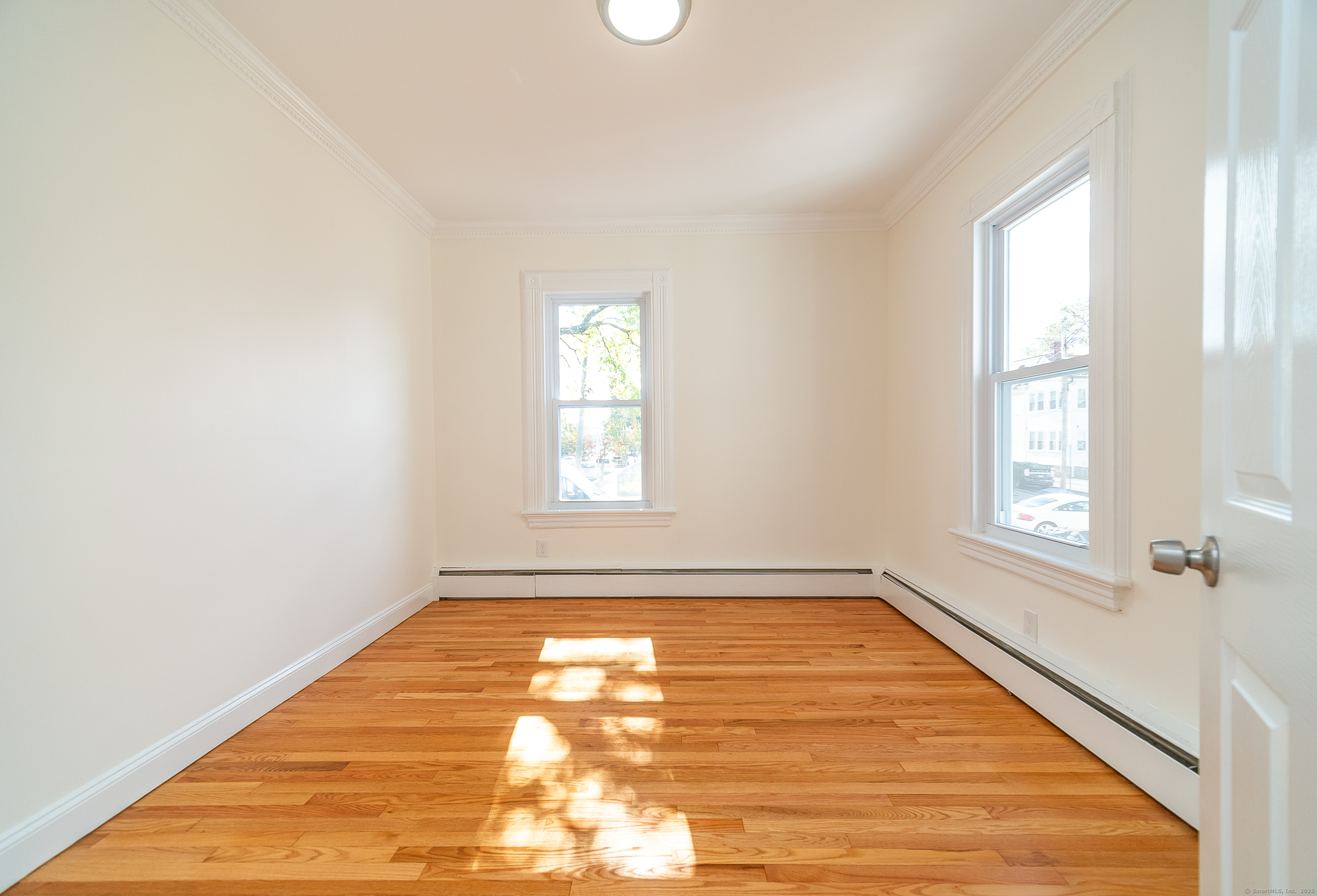 78 Warren Street Stamford, CT 06902 - Photo 15 of 40 an empty room with wooden floor and windows