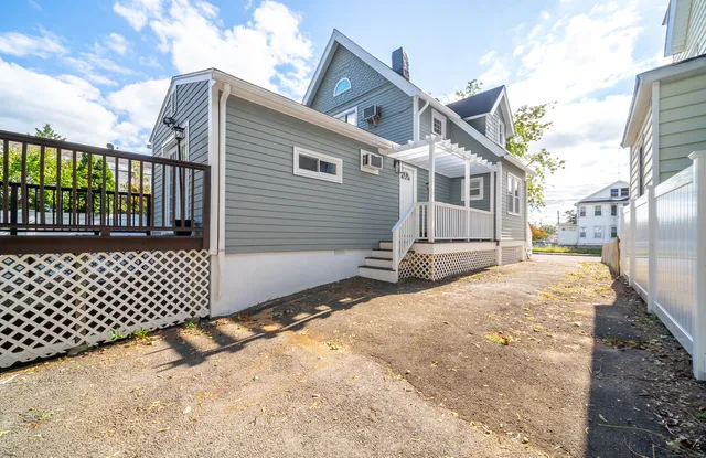 a view of a house with wooden fence