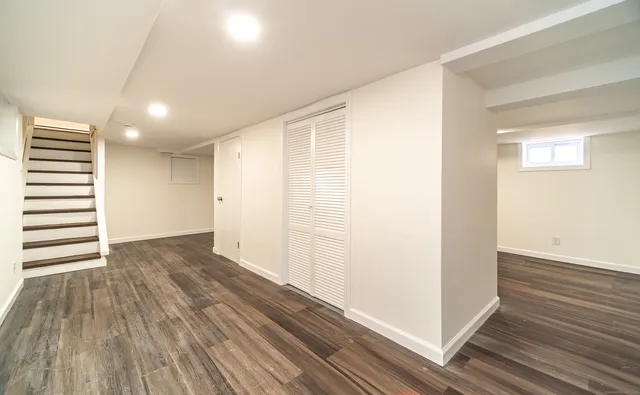 a view of a room with wooden floor