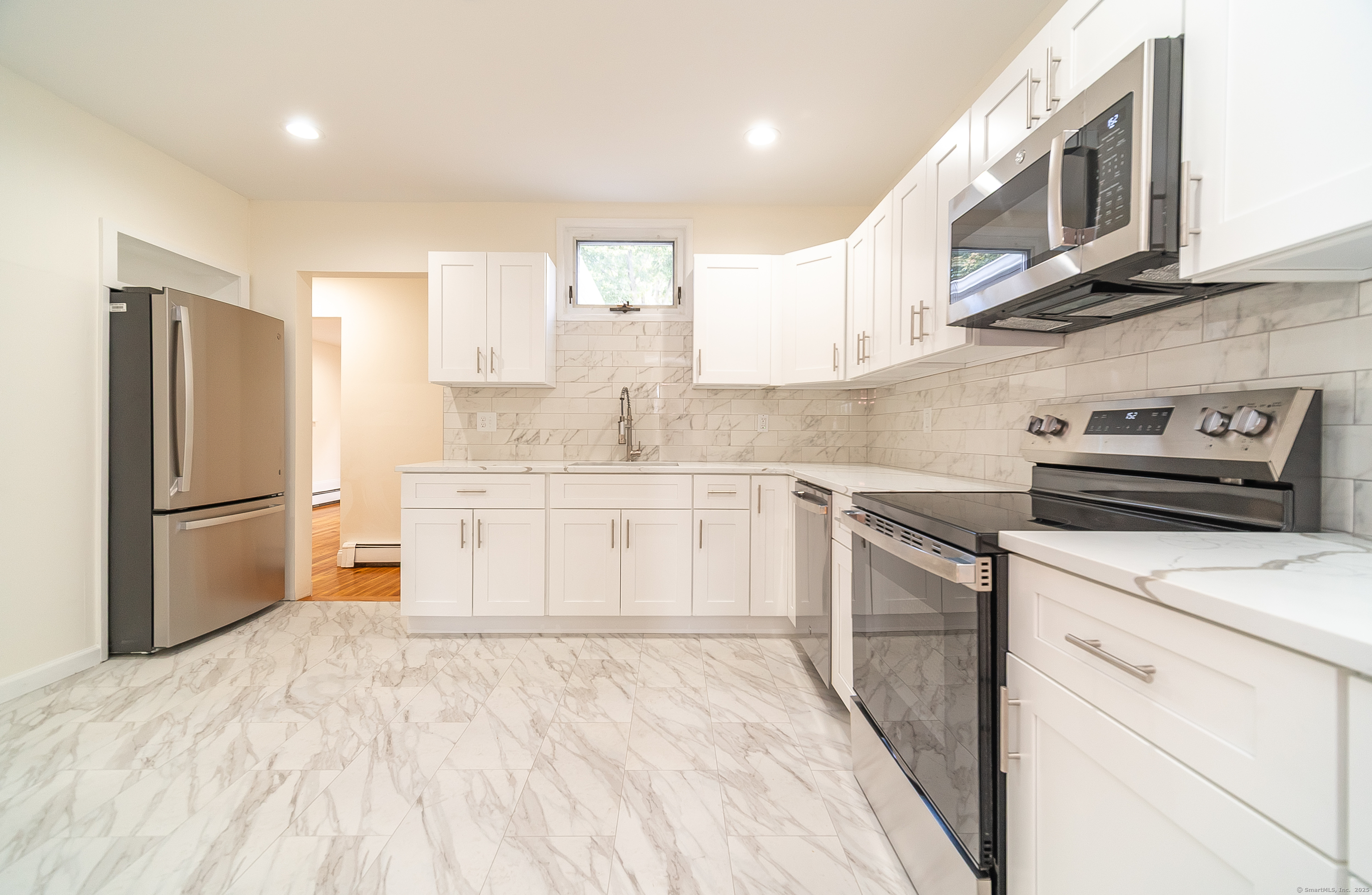78 Warren Street Stamford, CT 06902 - Photo 6 of 40 a kitchen with stainless steel appliances granite countertop a refrigerator sink and cabinets