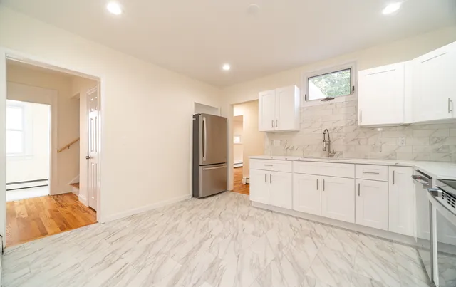 a kitchen with a refrigerator sink and cabinets