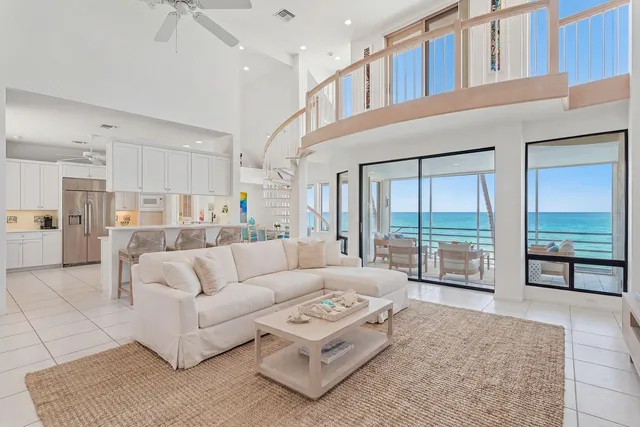 a living room with furniture and a large window with outer view