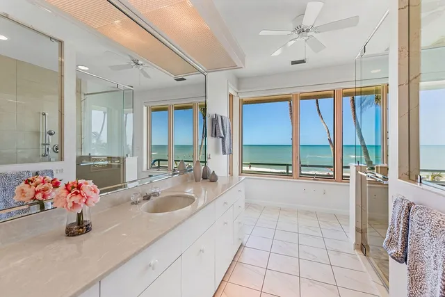 a large white kitchen with a large window
