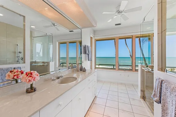 a large white kitchen with a large window