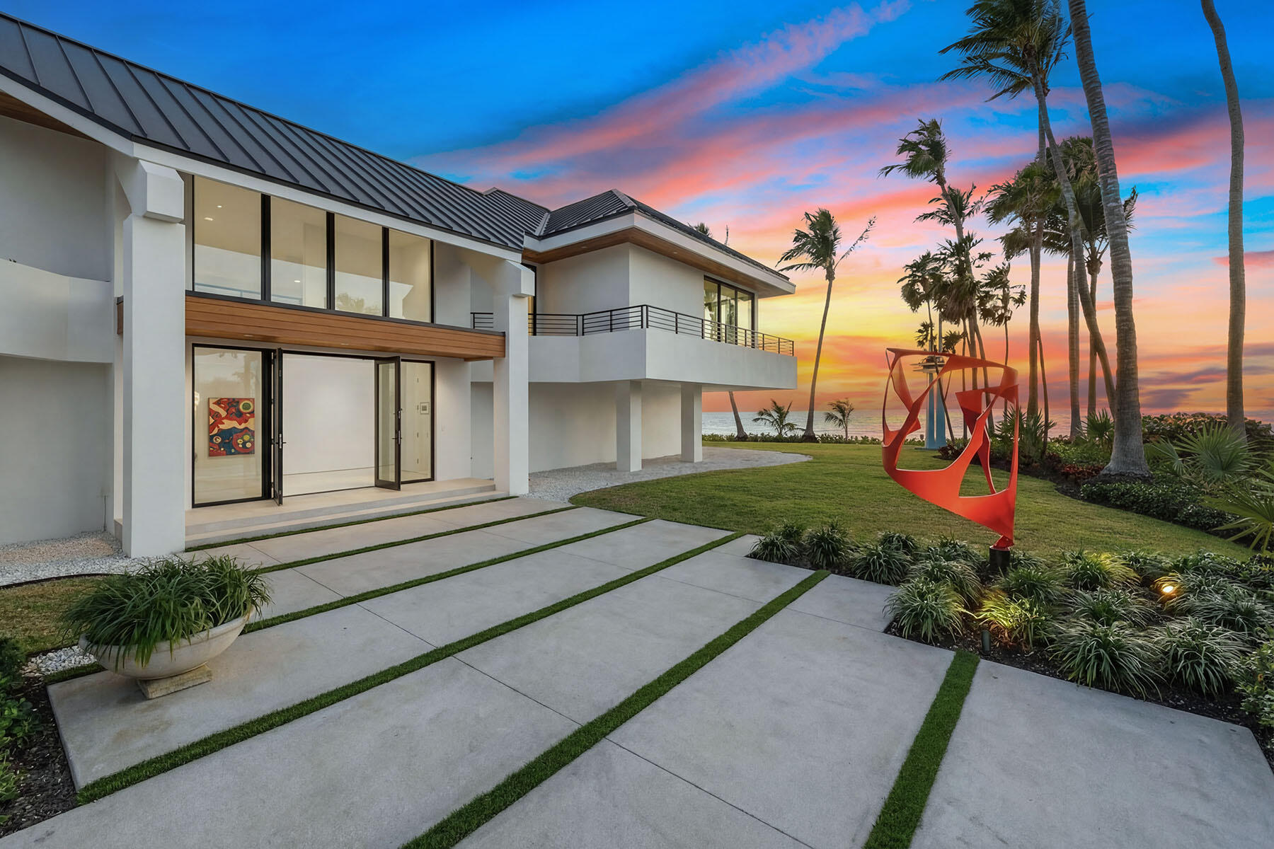 30 3rd Avenue South Naples, FL 34102 - Photo 5 of 17 a front view of a house with a yard and potted plants