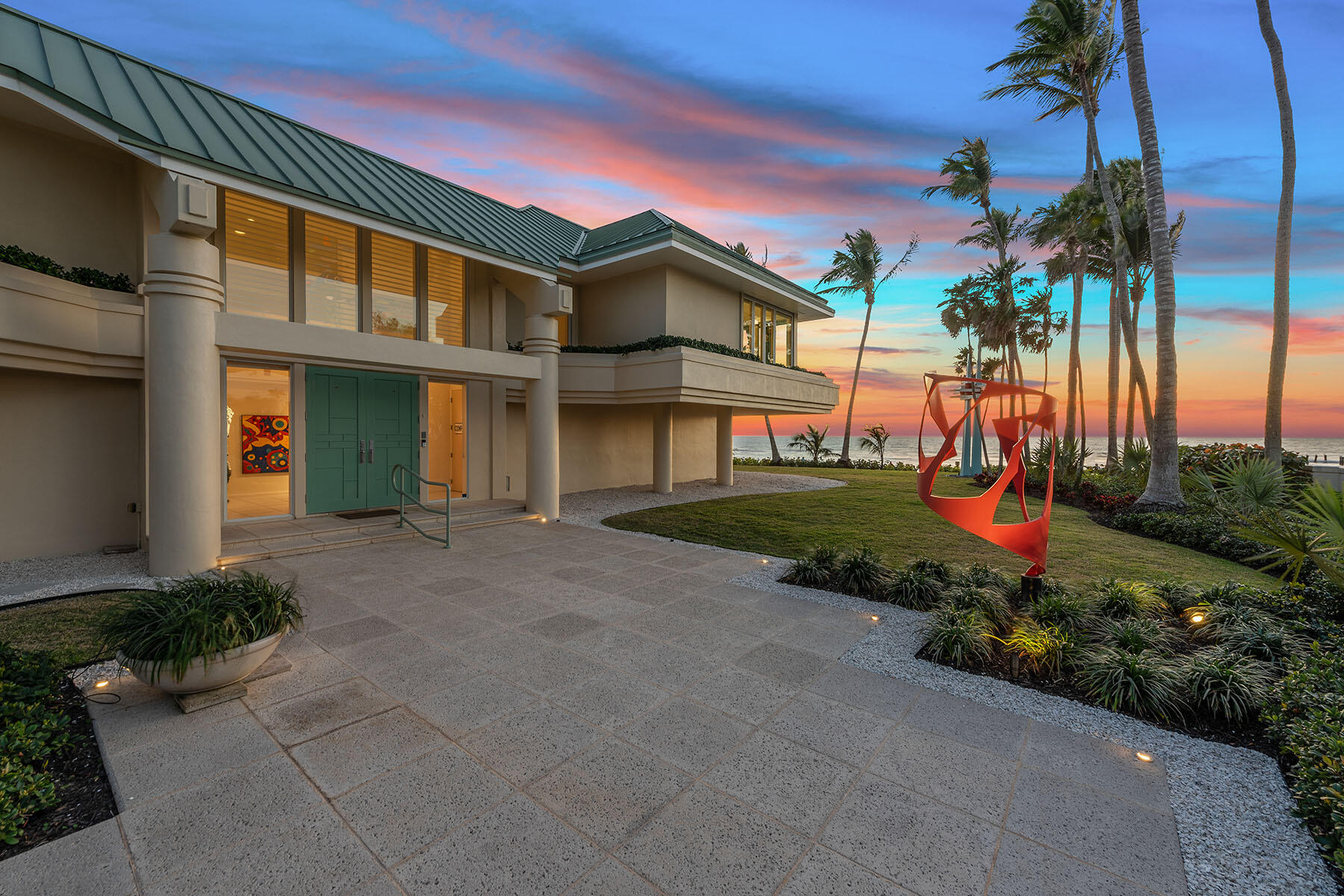 30 3rd Avenue South Naples, FL 34102 - Photo 7 of 17 a front view of a house with a yard and potted plants