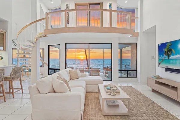 a living room with furniture and large window with outer view