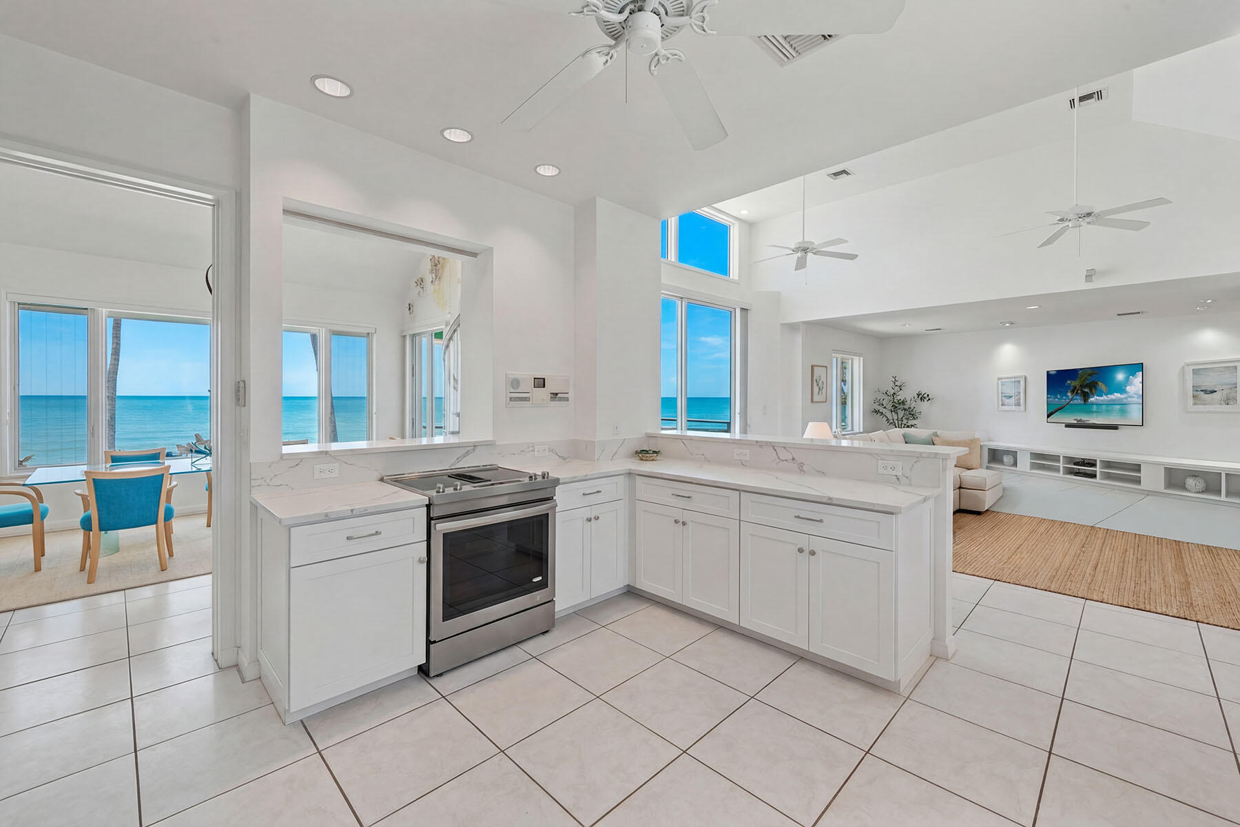 30 3rd Avenue South Naples, FL 34102 - Photo 8 of 17 a kitchen with white cabinets and white appliances
