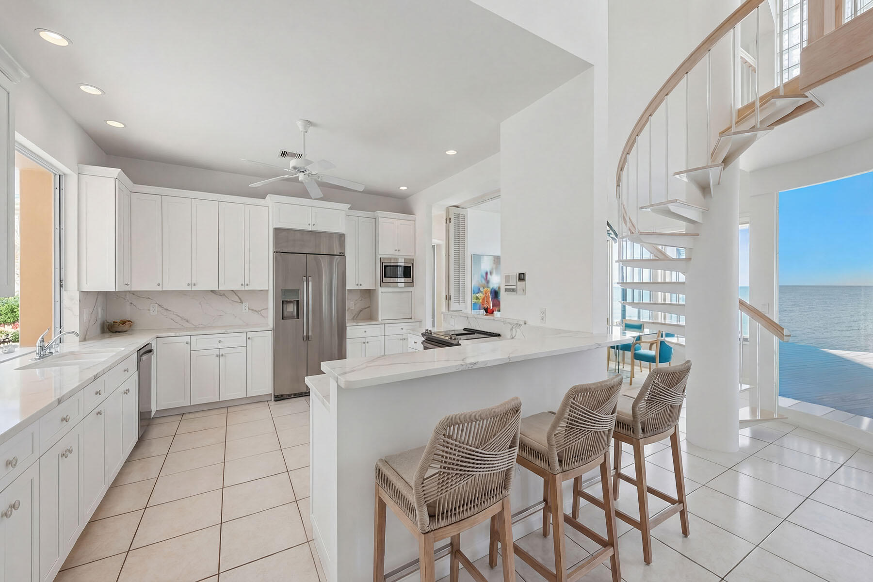 30 3rd Avenue South Naples, FL 34102 - Photo 9 of 17 a kitchen with stainless steel appliances kitchen island granite countertop a sink and cabinets