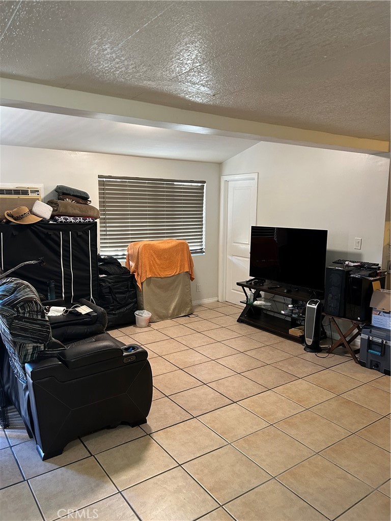 21900 Martin Street, Unit A8 Carson, CA 90745 - Photo 2 of 10 a bedroom with furniture and a flat screen tv