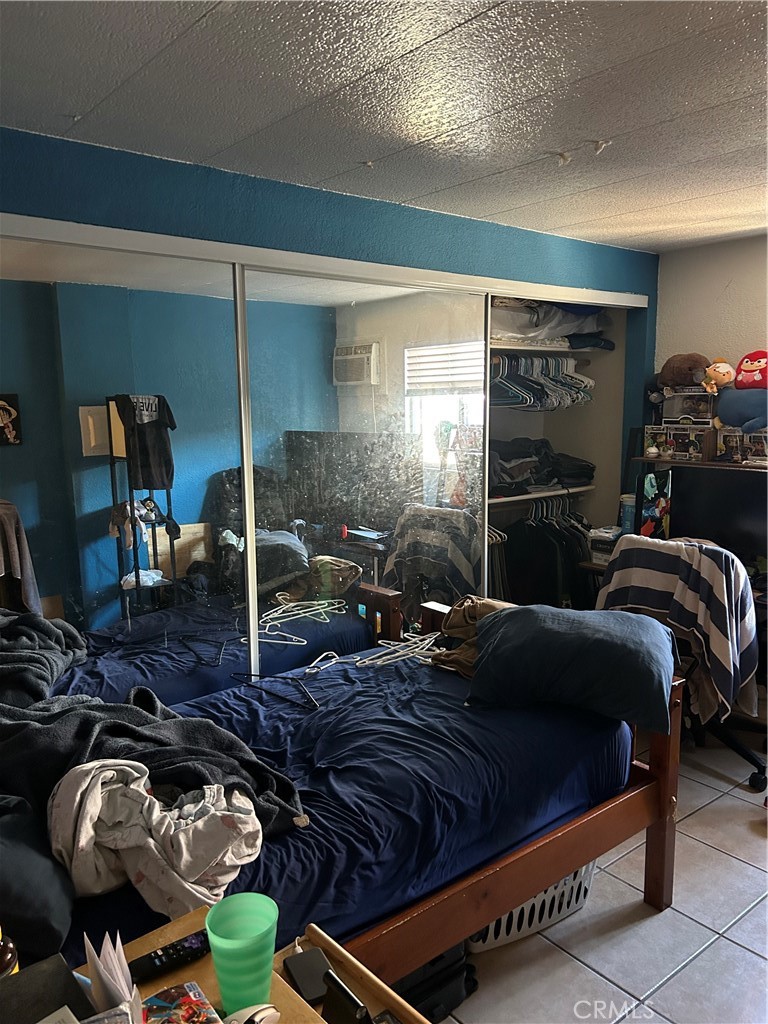 21900 Martin Street, Unit A8 Carson, CA 90745 - Photo 3 of 10 a bedroom with bed and a night stand