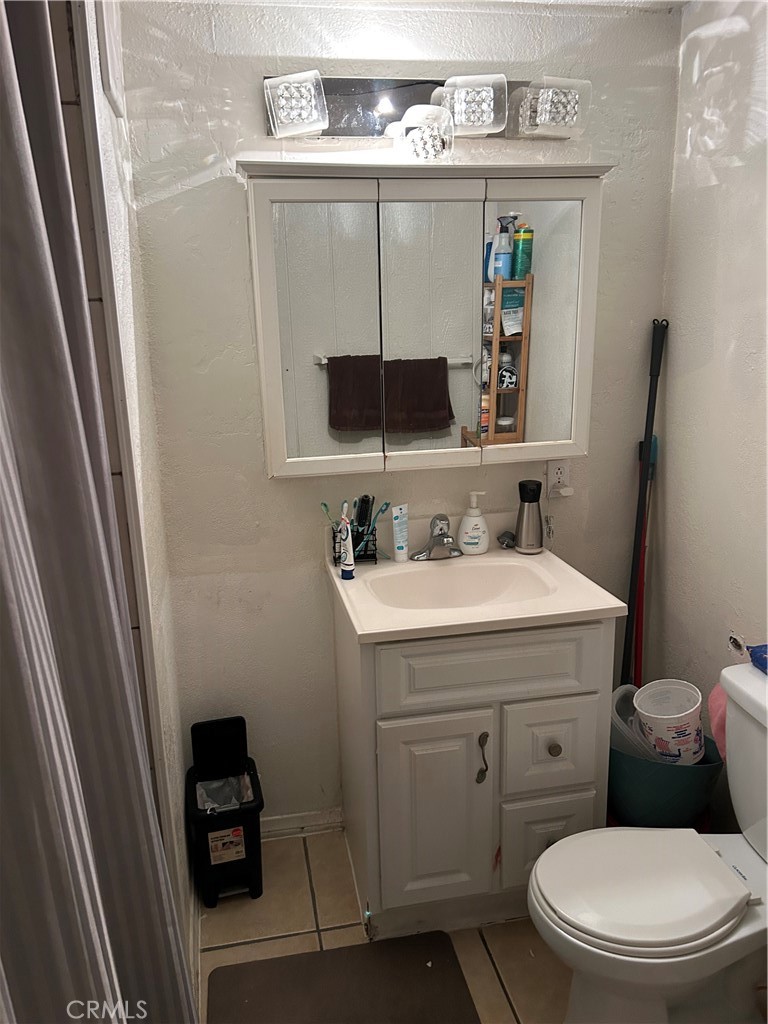 21900 Martin Street, Unit A8 Carson, CA 90745 - Photo 5 of 10 a bathroom with a sink a toilet and a mirror