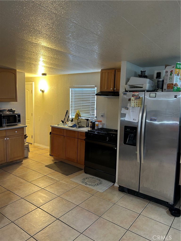 21900 Martin Street, Unit A8 Carson, CA 90745 - Photo 8 of 10 a kitchen with stainless steel appliances granite countertop a stove a sink and a refrigerator
