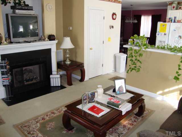 1201 Swingline Way Raleigh, NC 27610 - Photo 3 of 12 A shot of the living with plenty of space and a working gas log fireplace as the focal point with a TV niche above!