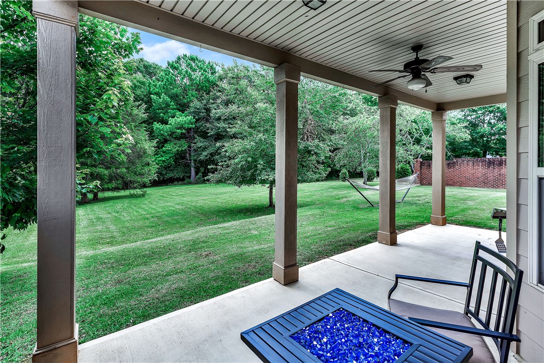 144 Buckland Drive Anderson, SC 29621 - Photo 24 of 48 A spacious covered patio overlooks a generous, well-kept lawn, perfect for outdoor relaxation and entertaining.