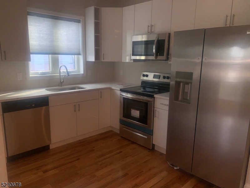 7 North Beverwyck Road, Unit B Lake Hiawatha, NJ 07034 - Photo 2 of 5 a kitchen with a sink stove and refrigerator