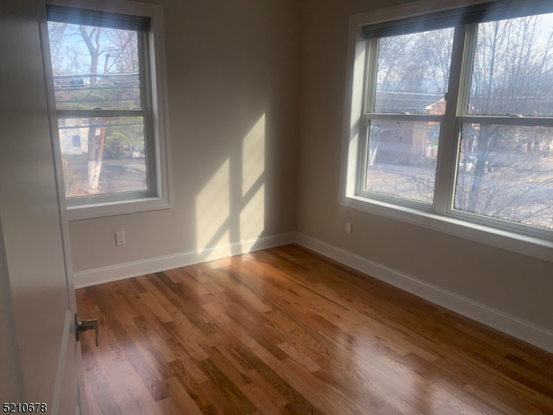 7 North Beverwyck Road, Unit B Lake Hiawatha, NJ 07034 - Photo 3 of 5 an empty room with wooden floor and windows