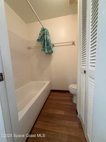 a bathroom with a bathtub and shower