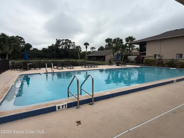 swimming pool view with a outdoor seating space