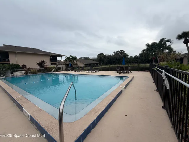 a view of swimming pool with seating space and wooden floor