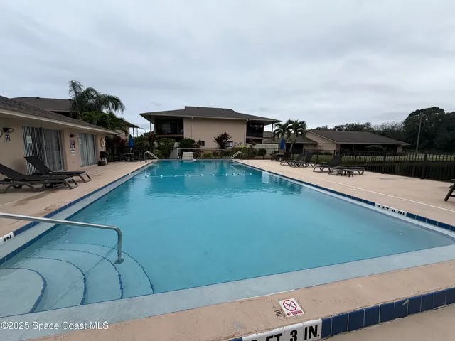 a view of a swimming pool and lounge chair