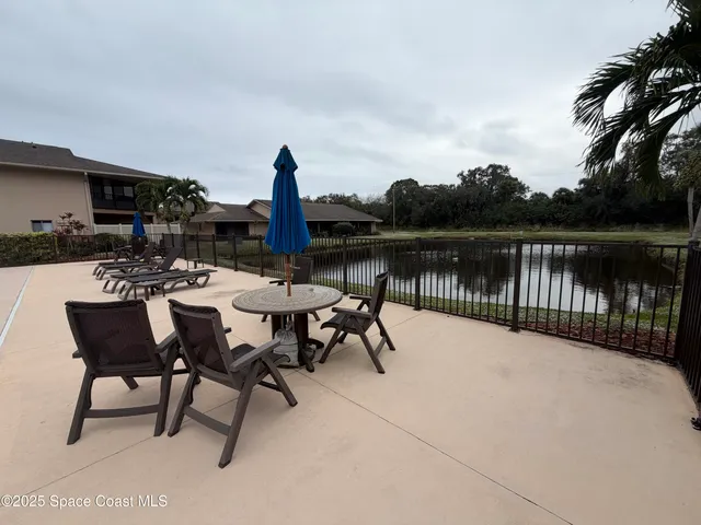 a view of a lake with table and chairs