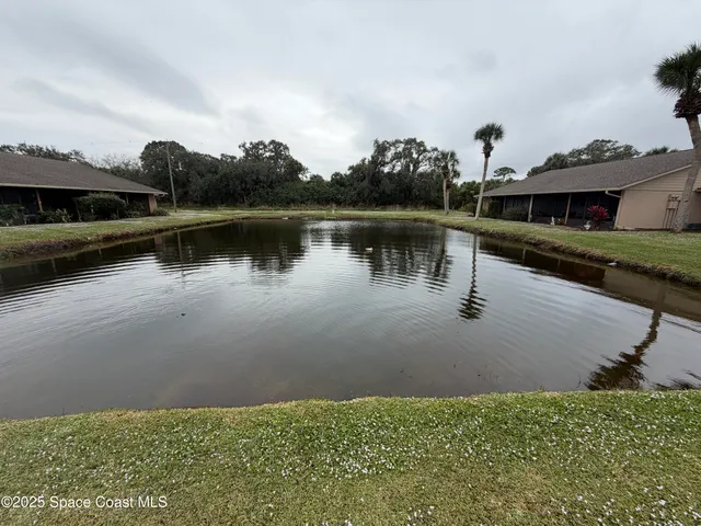 a view of a lake with a house in the background