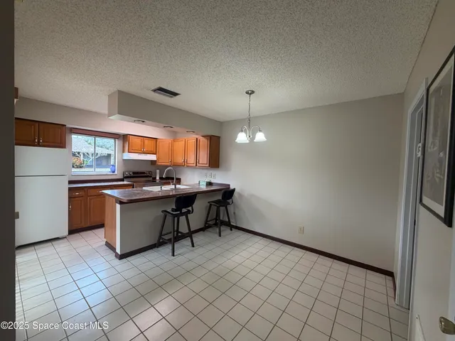 a kitchen with a sink and a refrigerator
