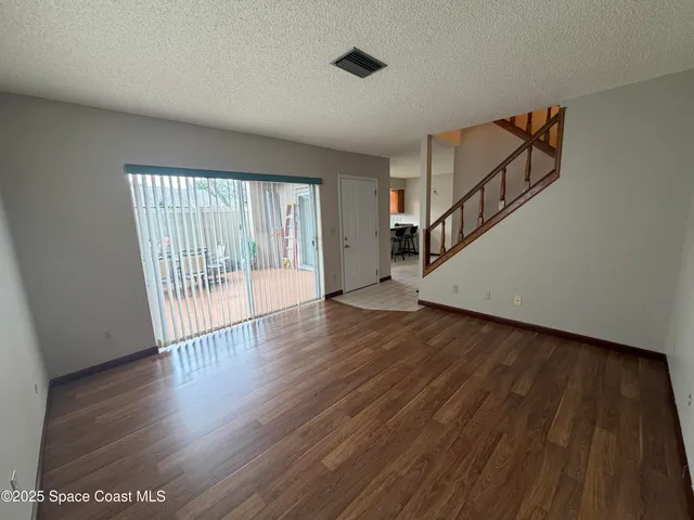 a view of an entryway with wooden floor