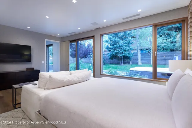 a bedroom with a bed and glass window