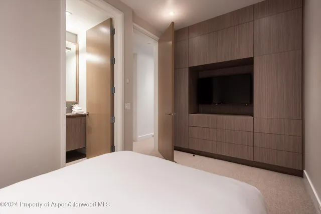 a bedroom with a bed and a mirror