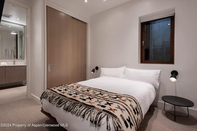 a bedroom with a bed and a lamp